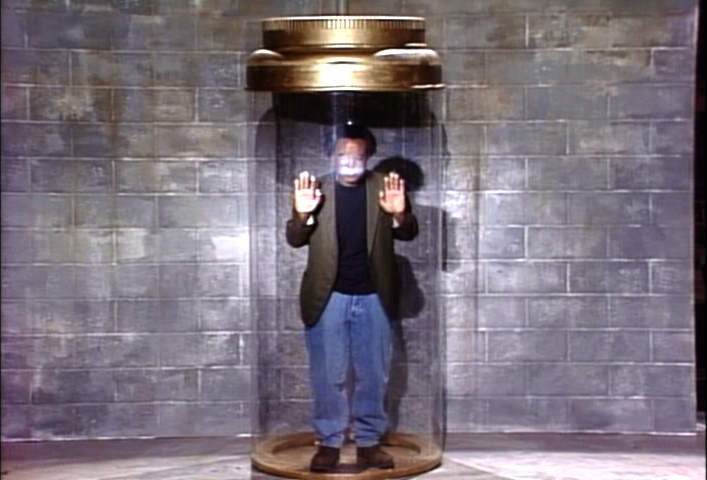 Tim Meadows in a big jar in the basement