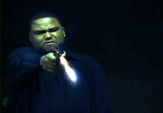 Anthony Anderson as Antwon Mitchell firing a gun