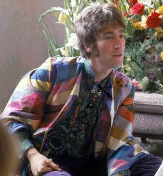 hip young John Lennon in his coat of many colors that Yoko no doubt made for him