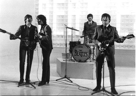 young Beatles in suits and ties