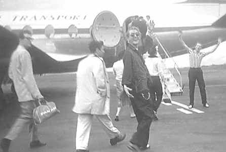 Buddy Holly, Paul Anka, and Jerry Lee Lewis boarding a plane