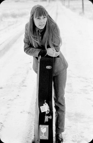 beautiful young Joni Mitchell on a lonesome snowy road