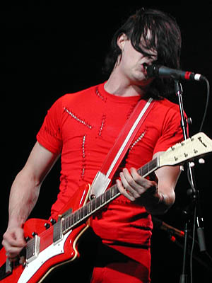 Jack White playing guitar on stage